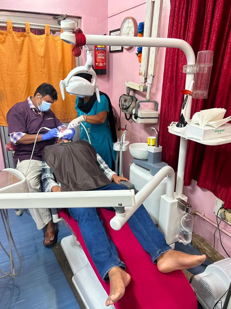 Dr. Ashutosh Choudhury treating a patient with assistant