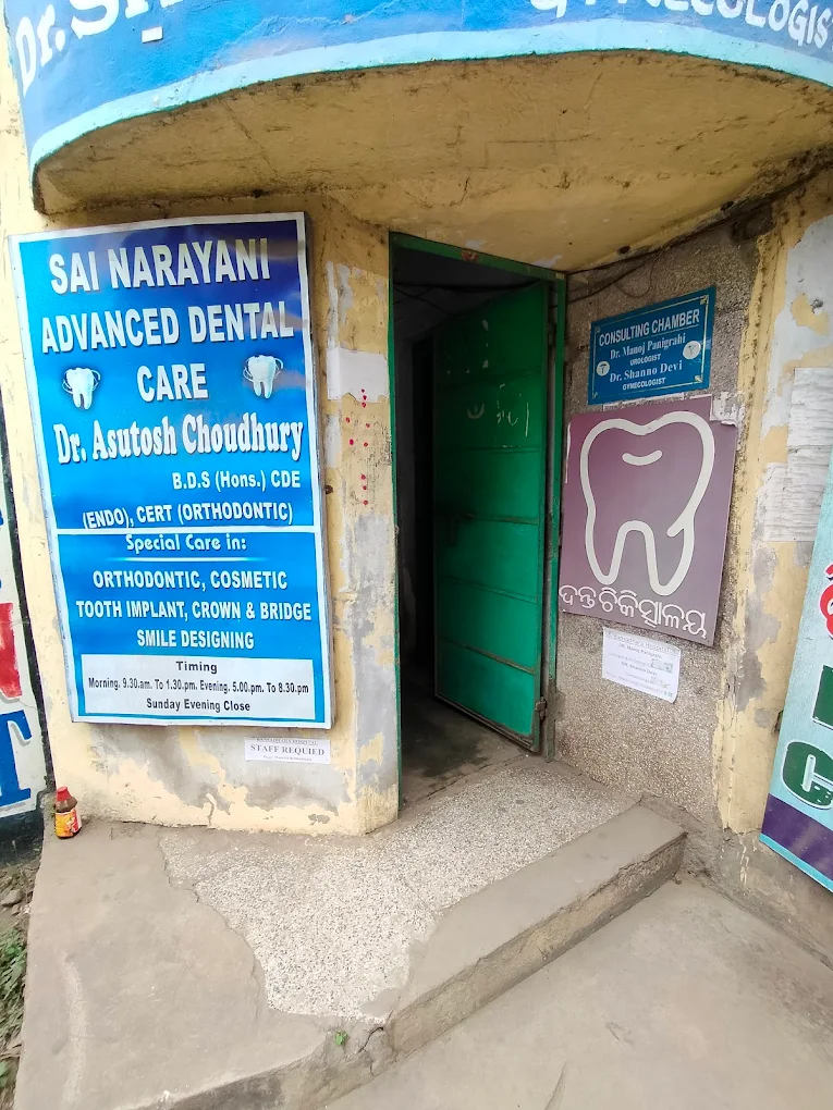 Clinic signboard at the entrance, listing services and timings